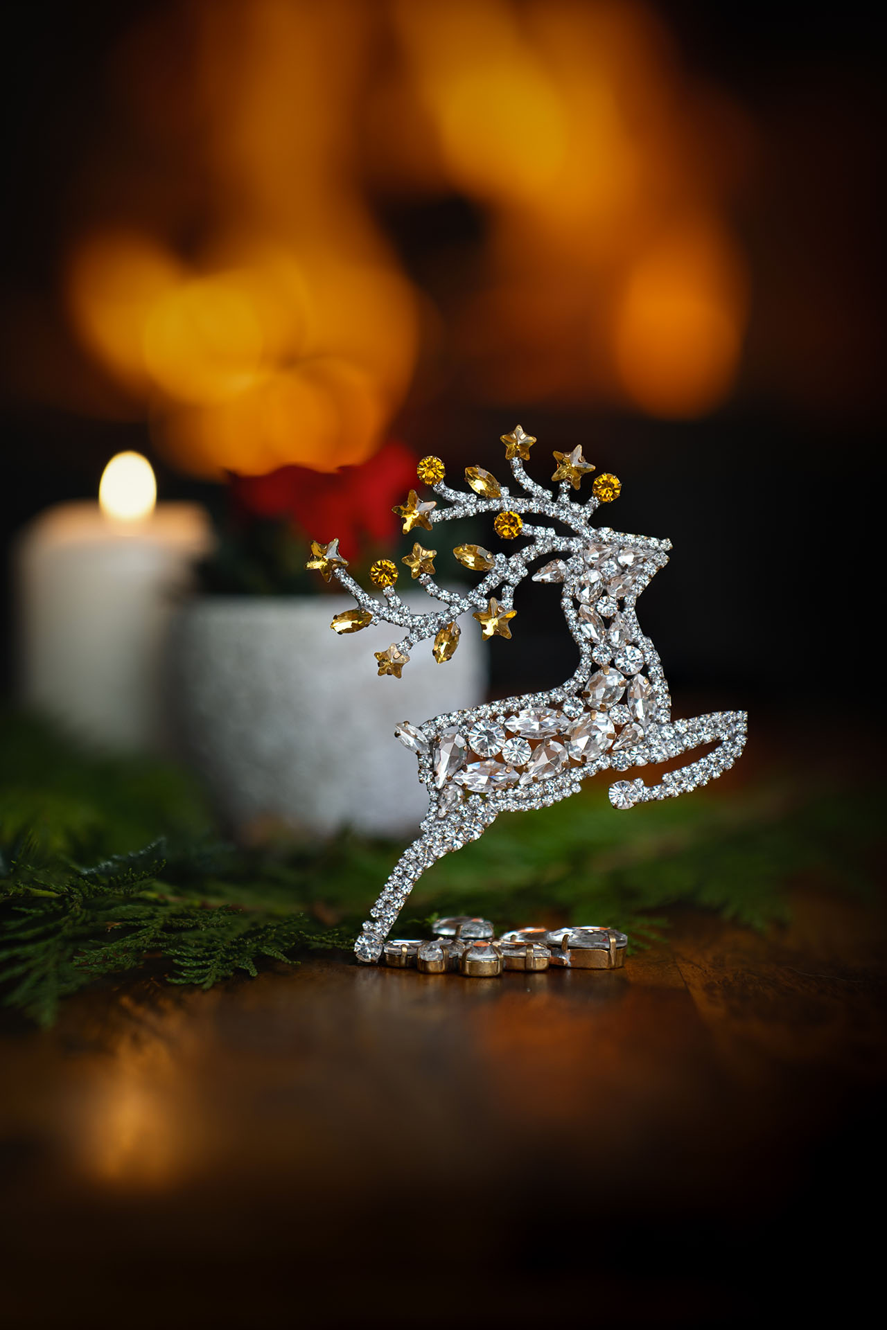 Decorative reindeer figurine with yellow rhinestones - facing right