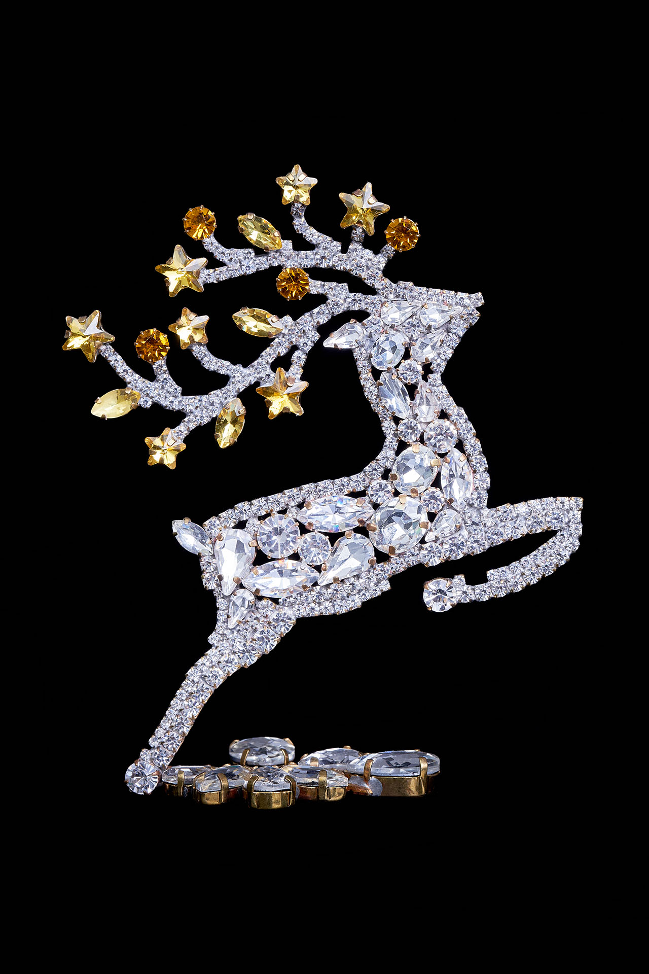 Decorative reindeer figurine with yellow rhinestones - facing right