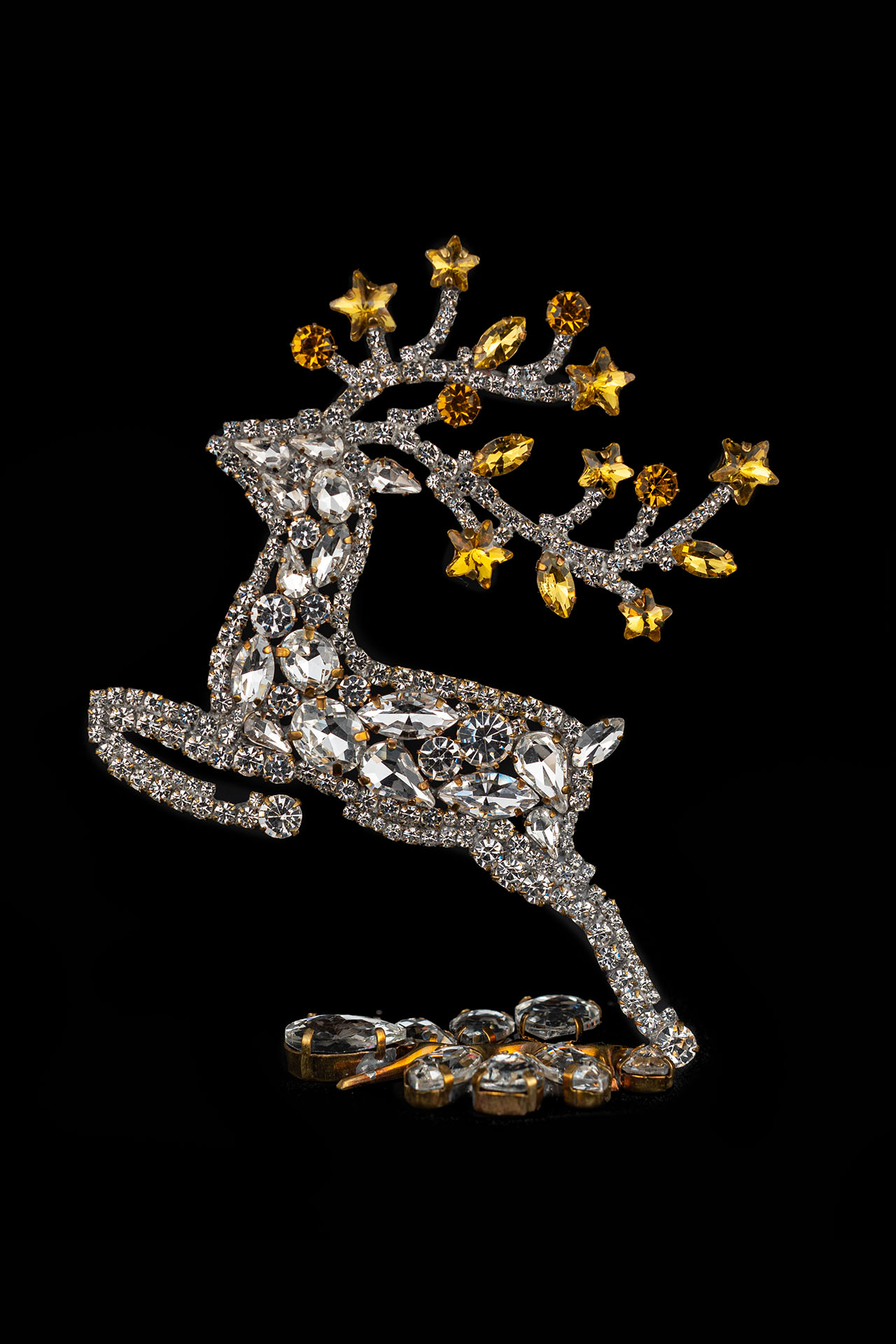 Decorative reindeer figurine with yellow rhinestones - facing left