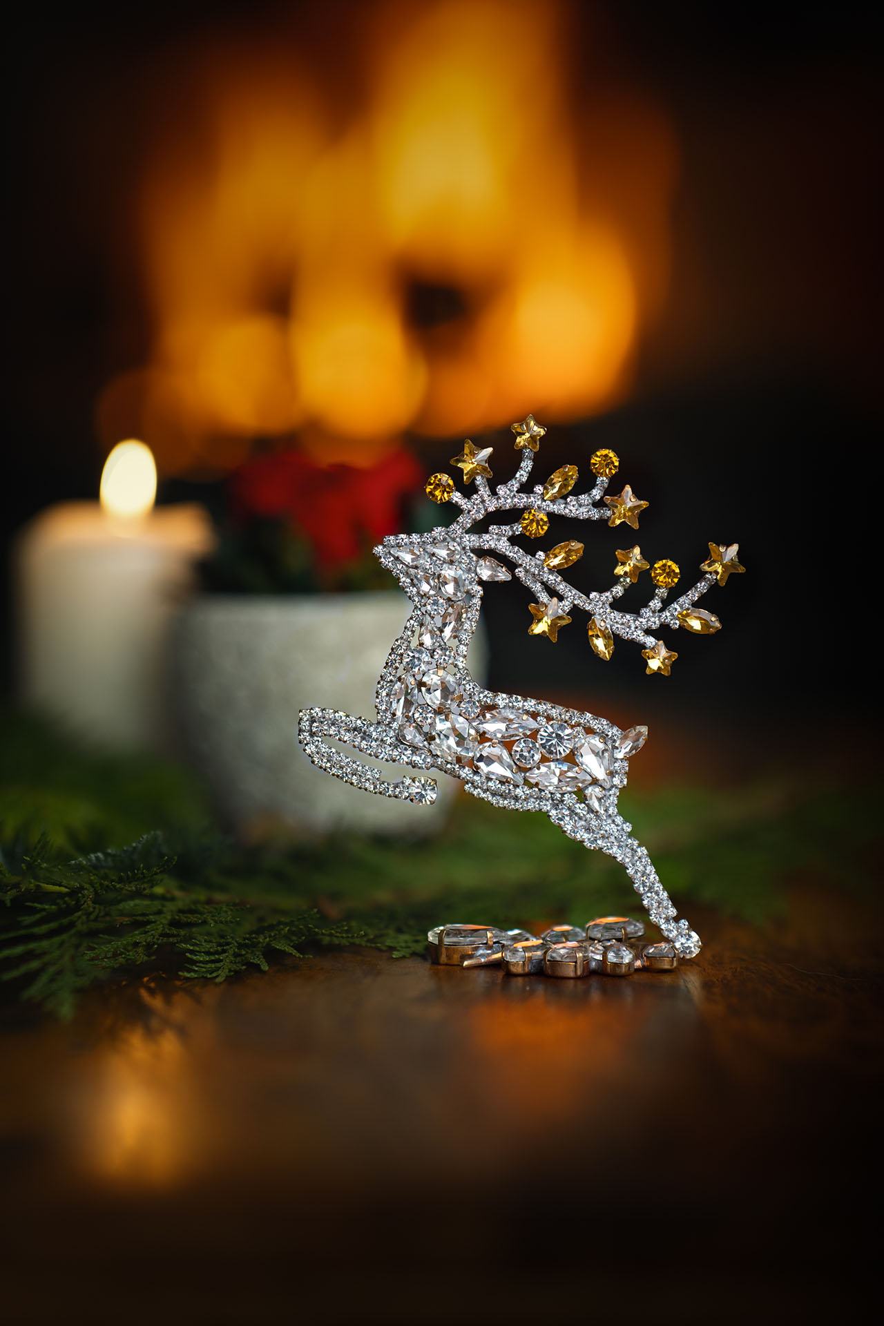 Decorative reindeer figurine with yellow rhinestones - facing left