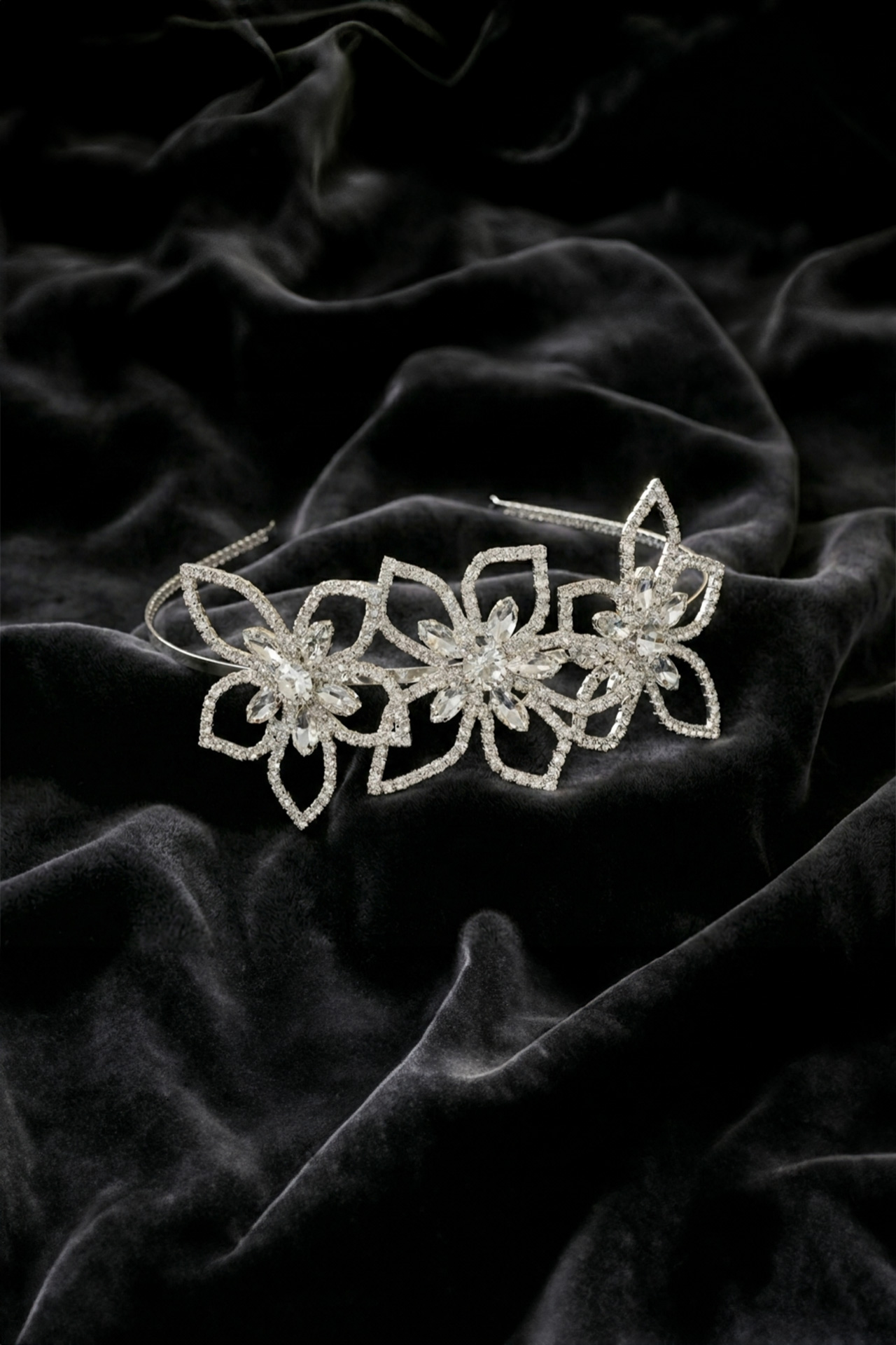 Silver floral tiara with precisely cut clear crystals arranged in a blooming flower pattern.
