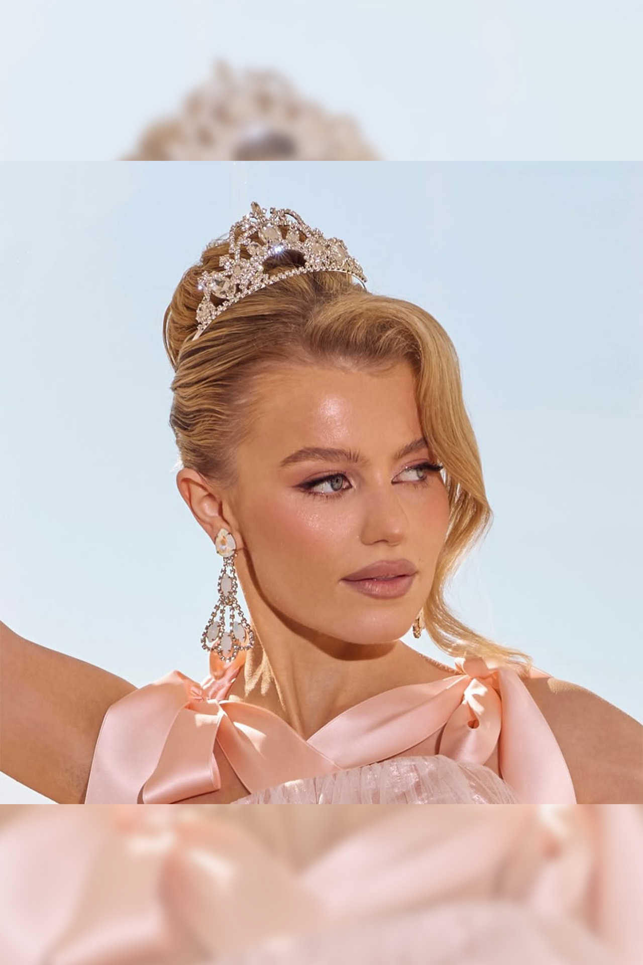 Silver crown tiara featuring a large central crystal surrounded by symmetrical patterns of smaller clear rhinestones.