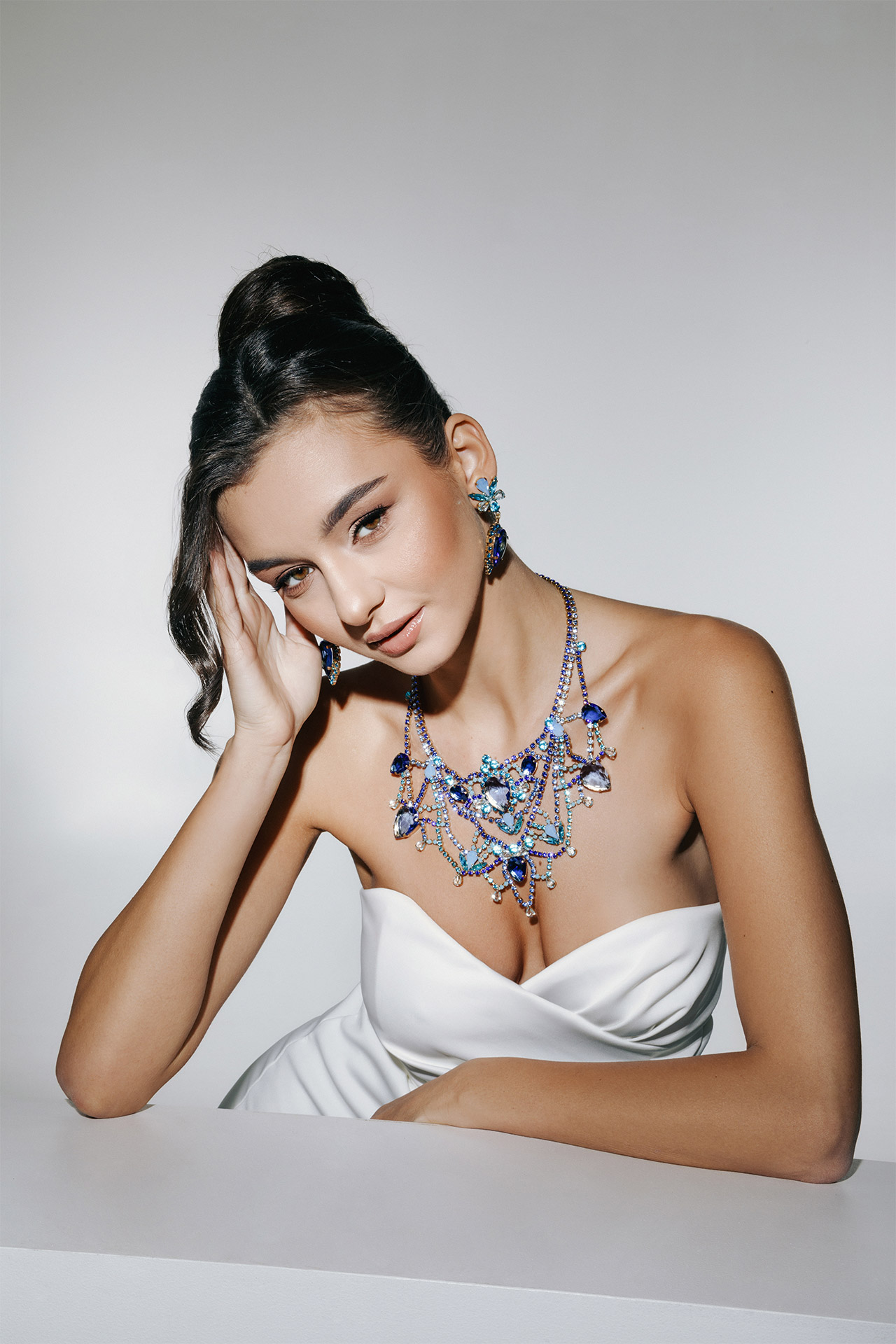 Blue rhinestone necklace and earrings in design like crystal lace