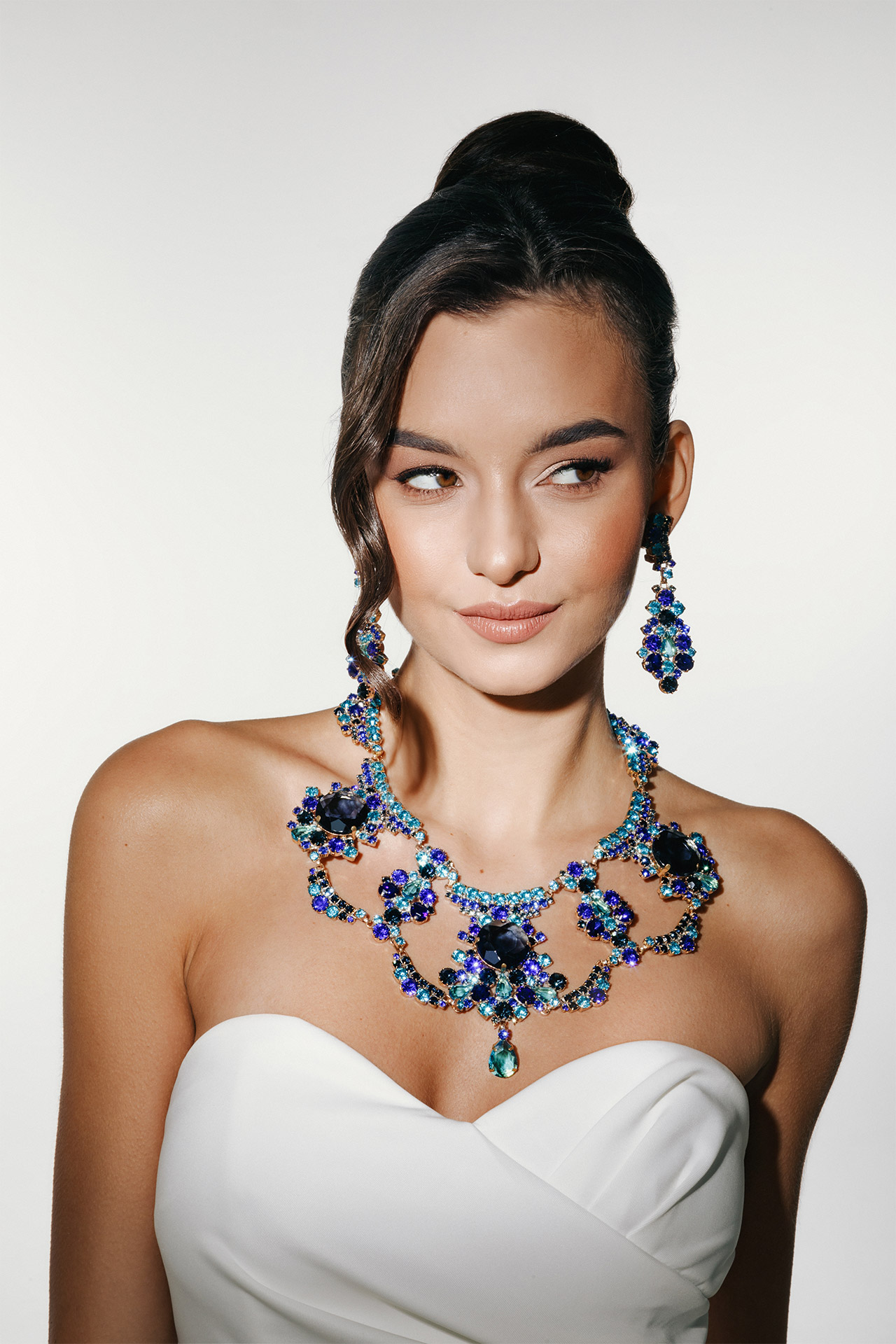 Costume jewelry necklace and earrings with blue rhinestones