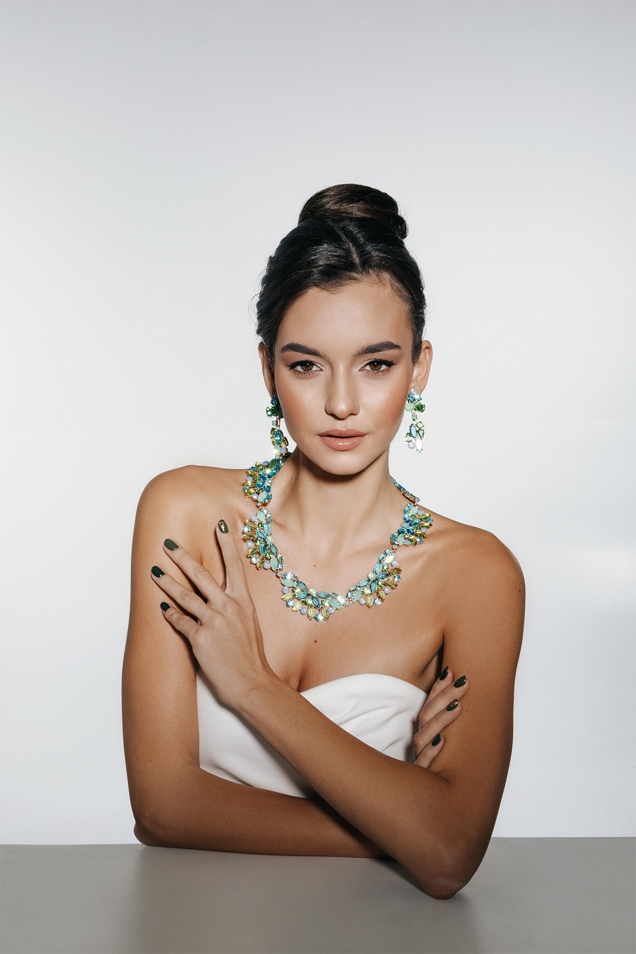 Rhinestone necklace and earrings set with small blue and green crystals