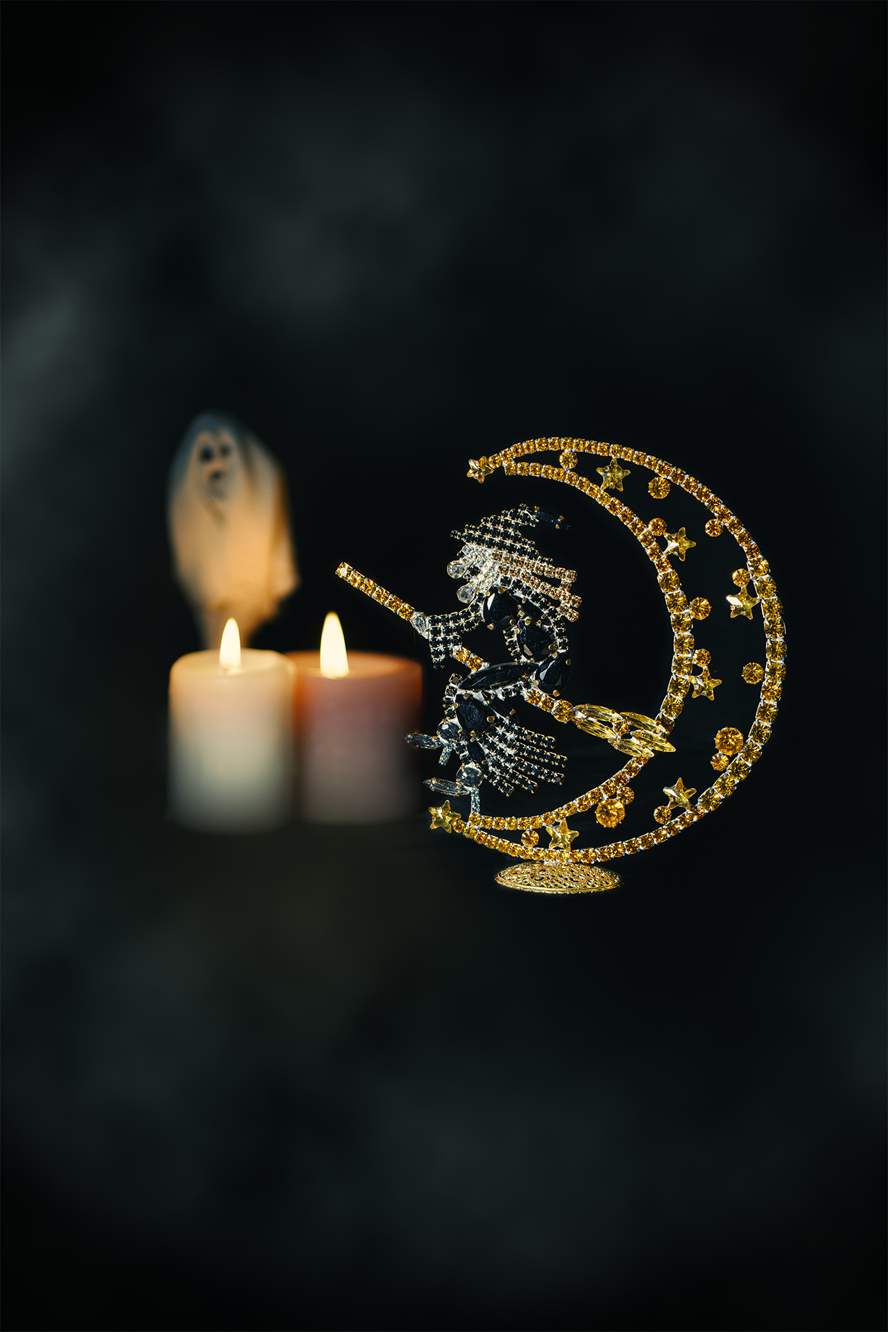 Rhinestone witch flying on a broomstick, sitting on a crescent moon.