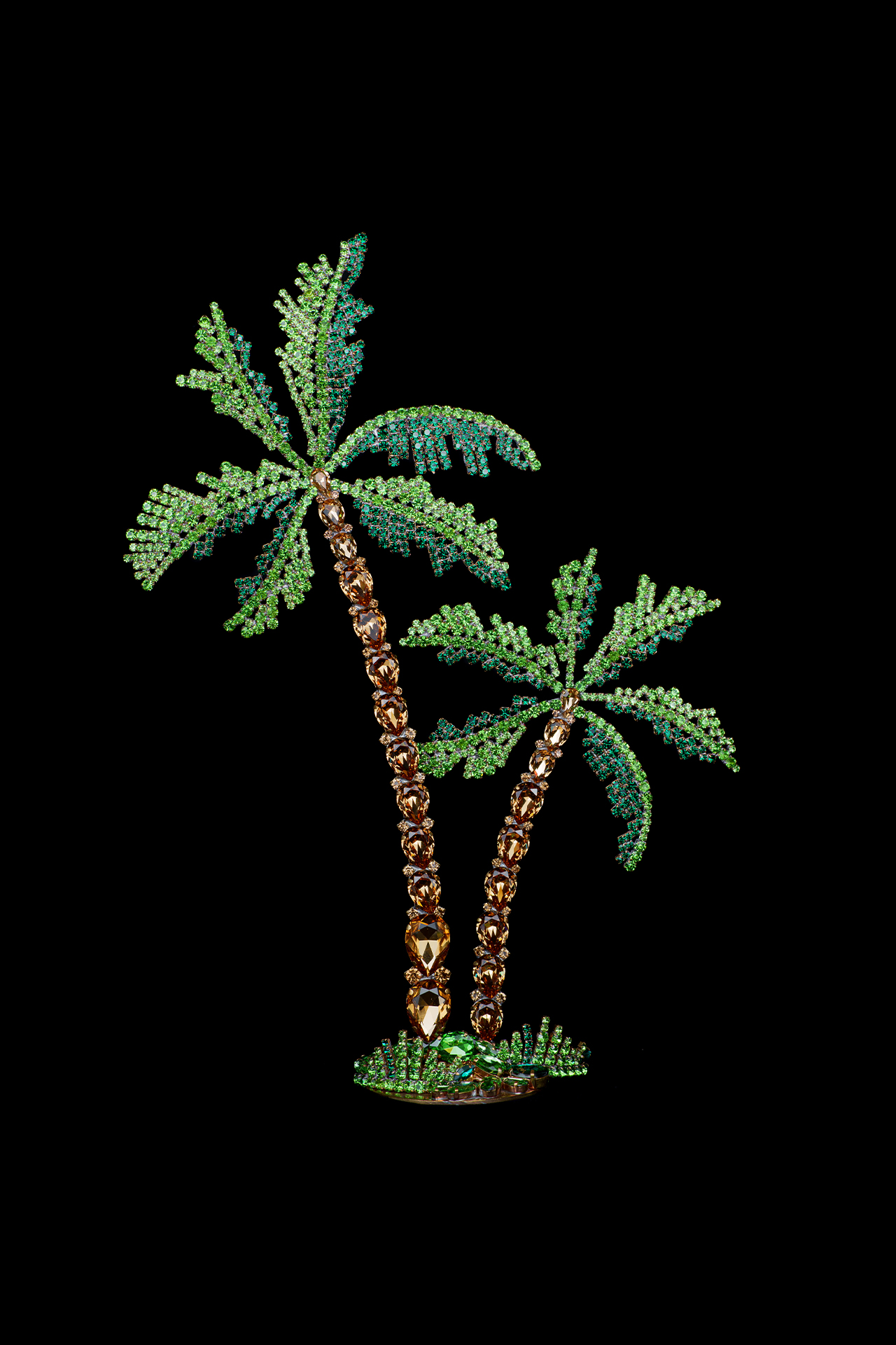 Rhinestone palm trees placed on a grass-like base