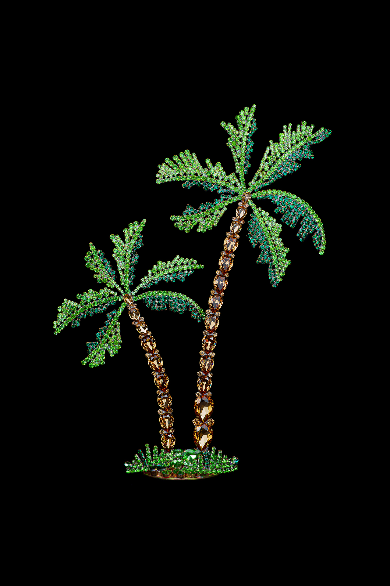 Rhinestone palm trees placed on a grass-like base