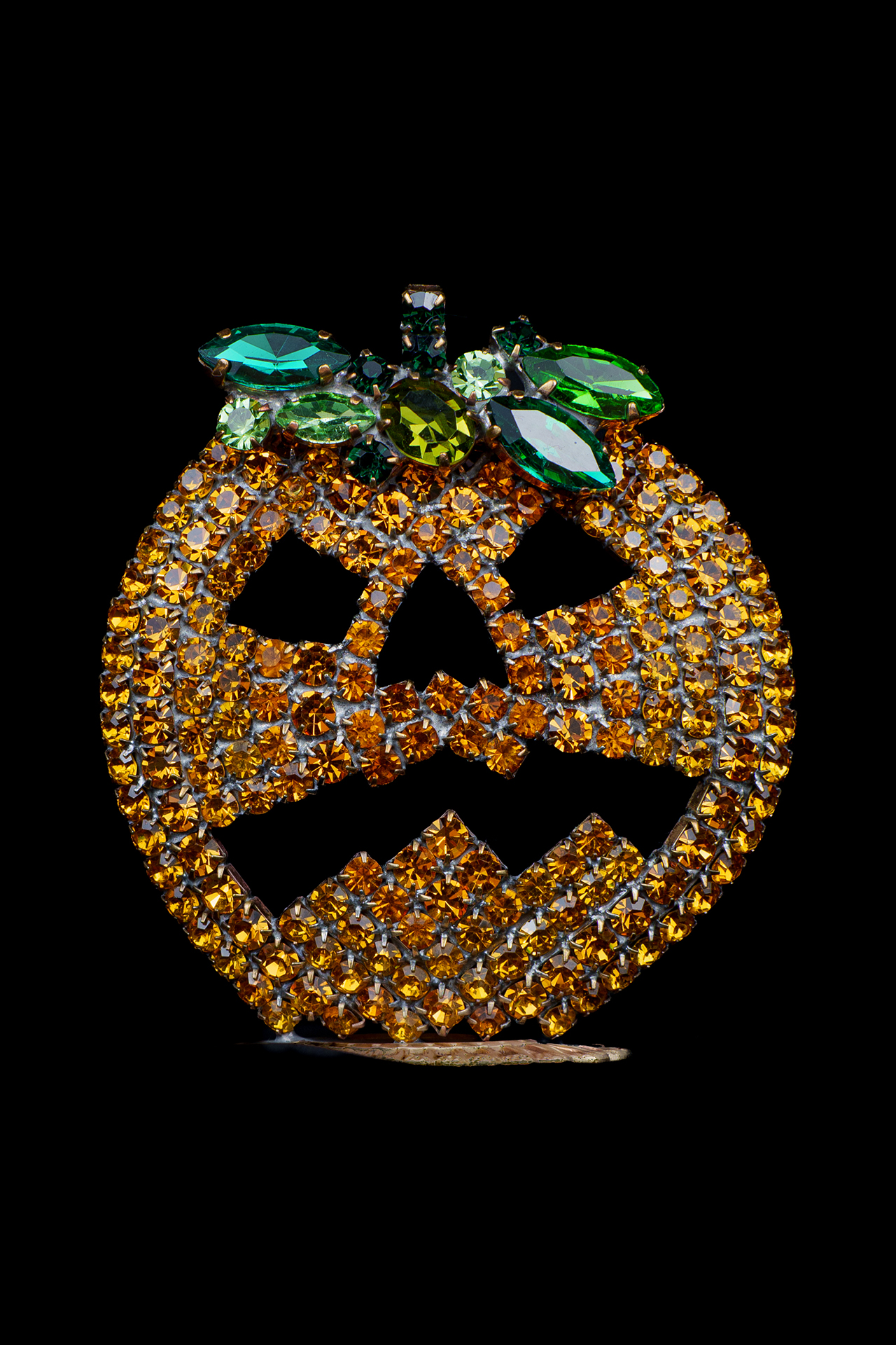 Rhinestone pumpkin with carved jack-o’-lantern face