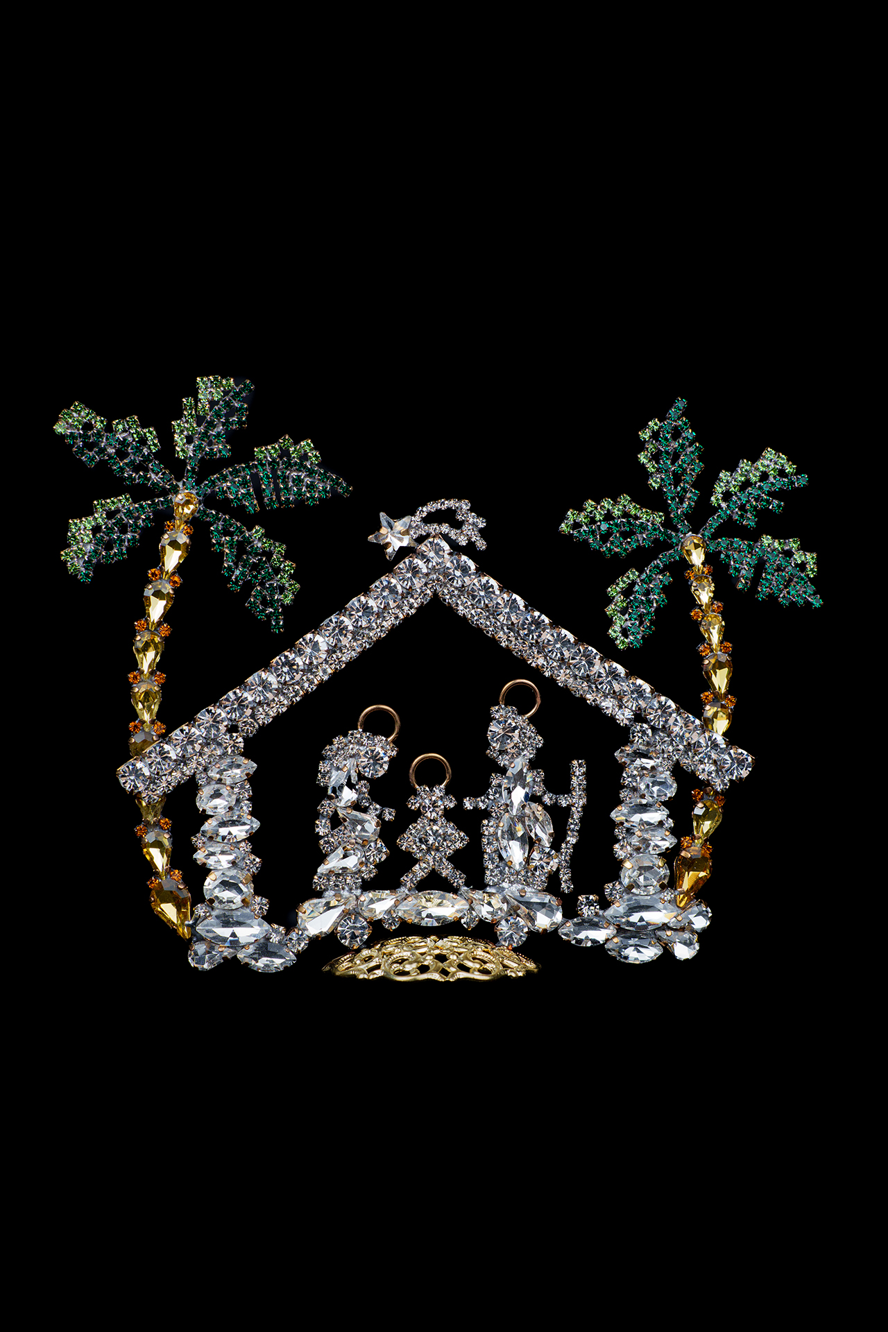 Nativity scene with Mary, Joseph, and baby Jesus and two green rhinestone palm trees