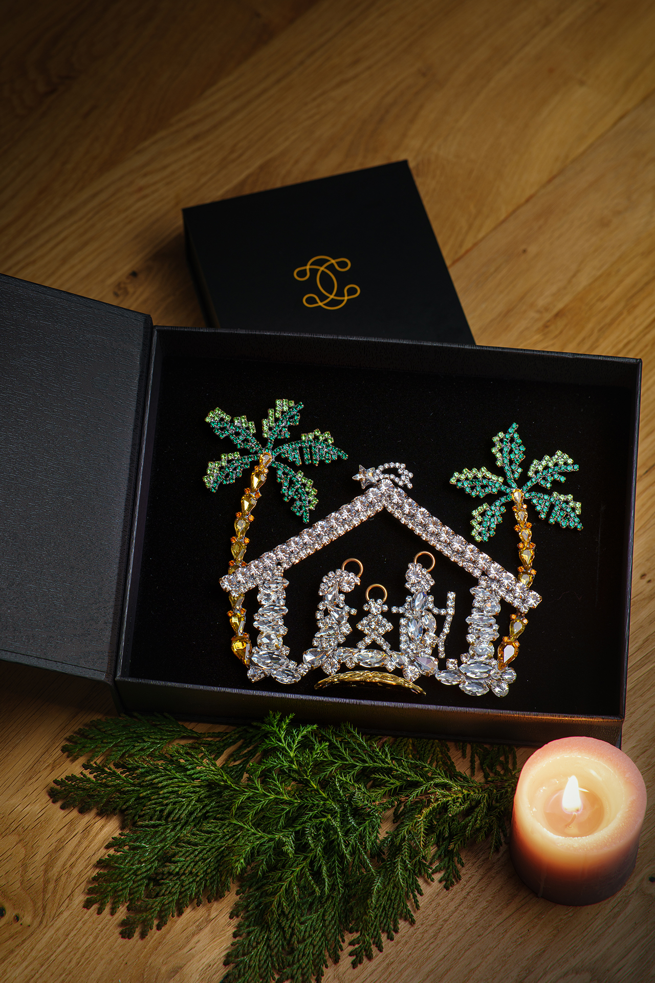 Nativity scene with Mary, Joseph, and baby Jesus and two green rhinestone palm trees