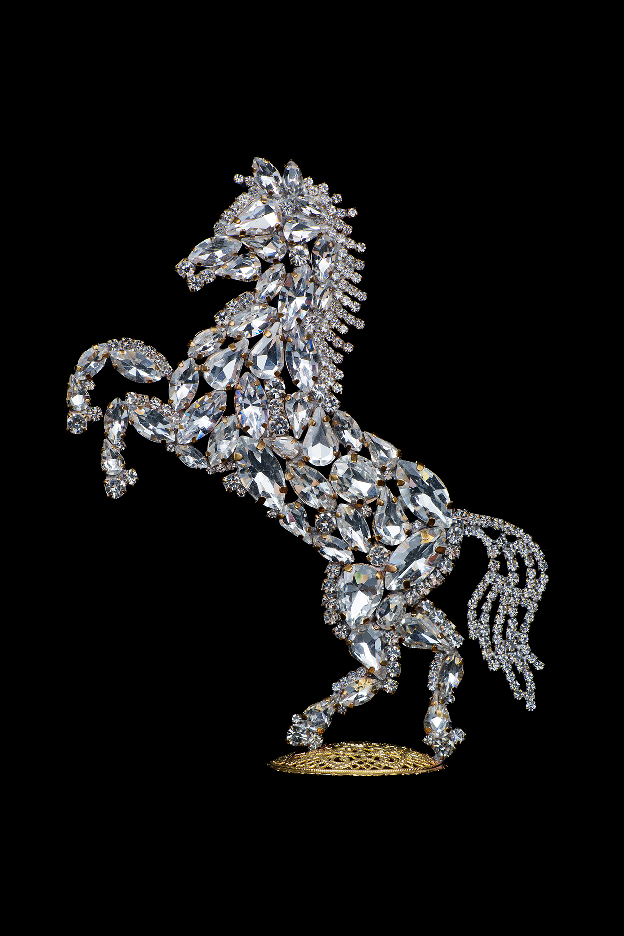 Bedazzled horse figurine made from clear rhinestones, facing to the left