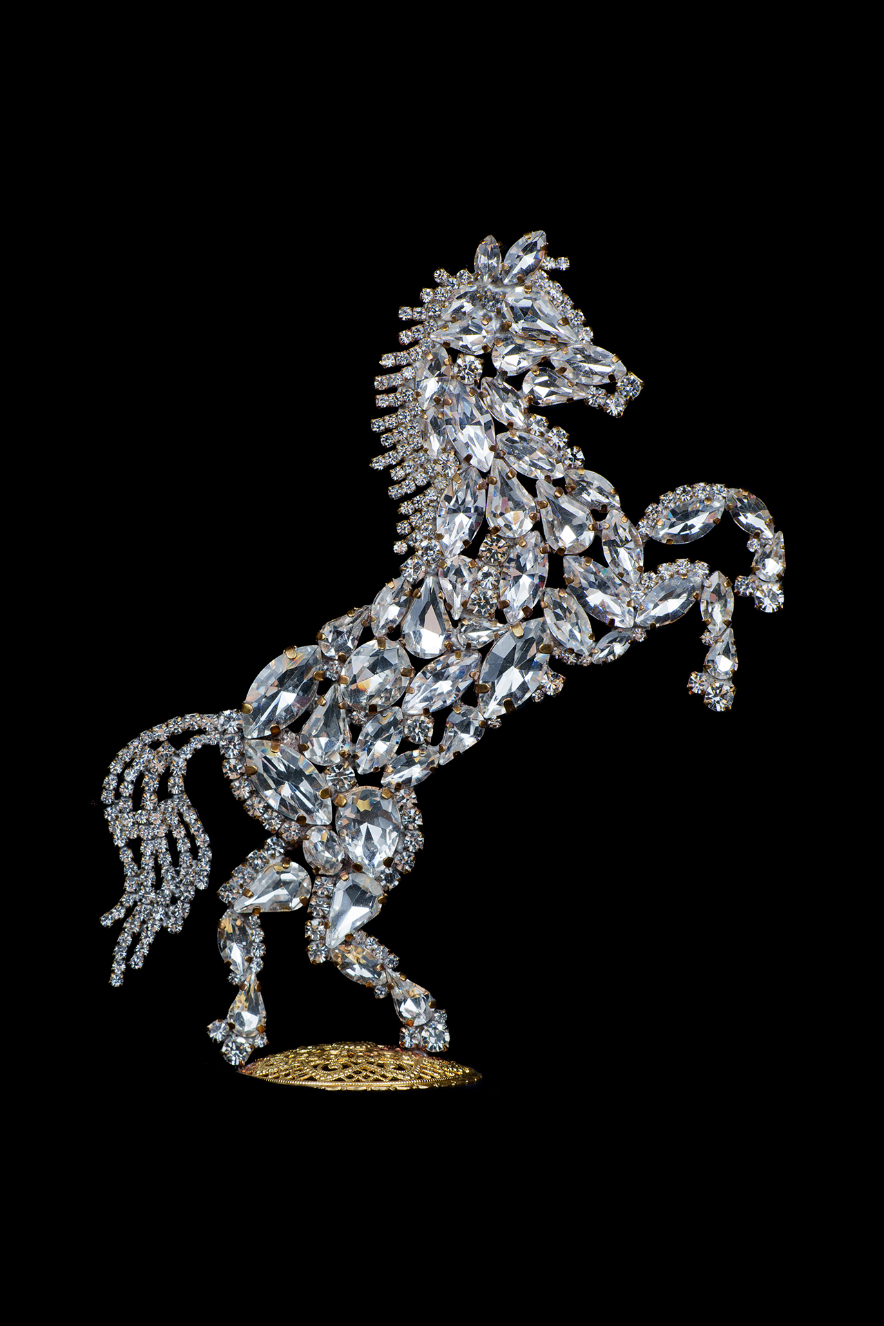 Bedazzled horse figurine made from clear rhinestones, facing to the right