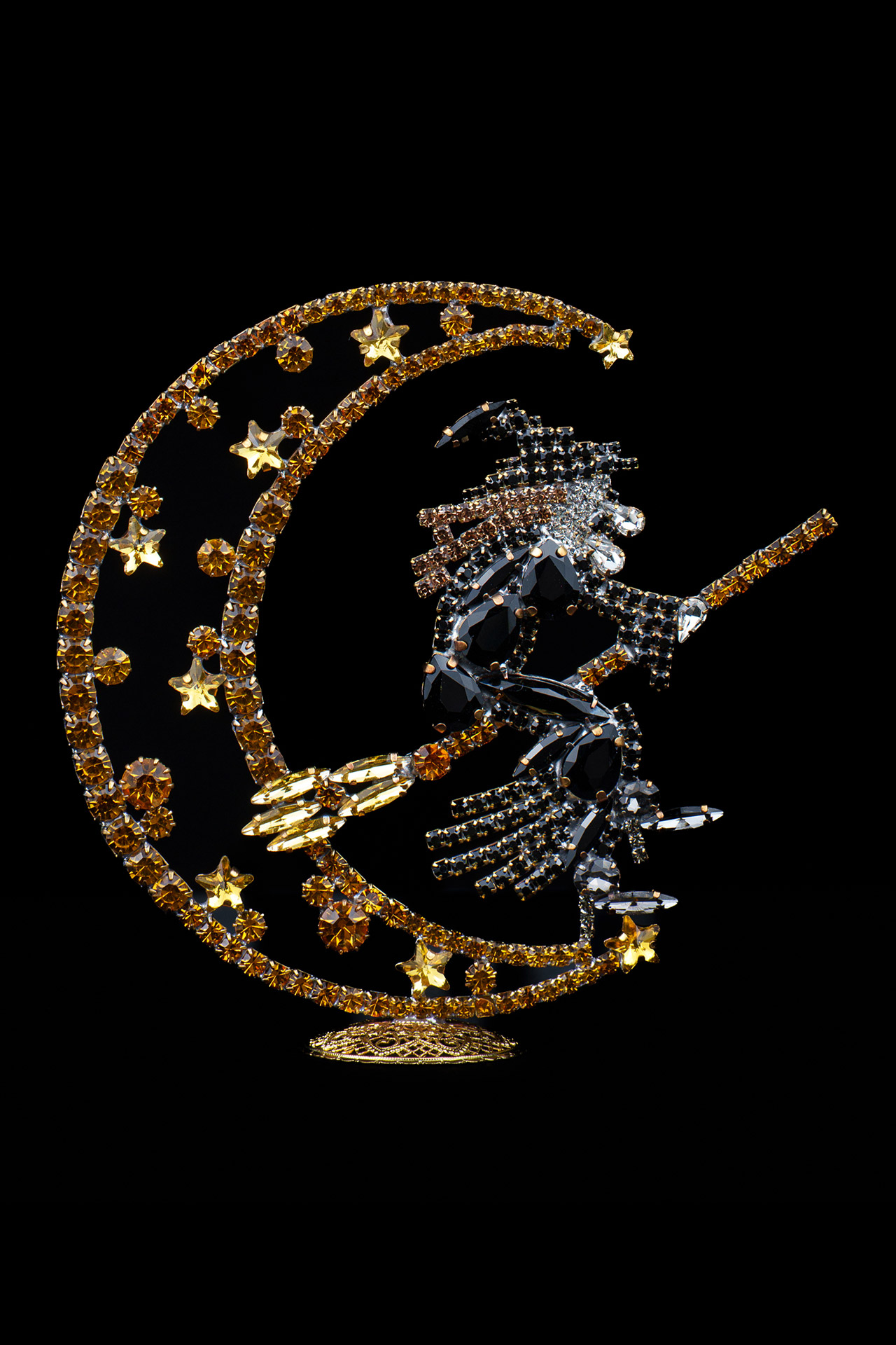 Right facing rhinestone witch flying by the moon