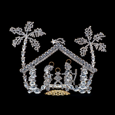 Nativity scene with Mary, Joseph, and baby Jesus and two clear rhinestone palm trees.