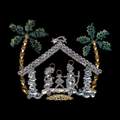 Nativity scene with Mary, Joseph, and baby Jesus and two green rhinestone palm trees.