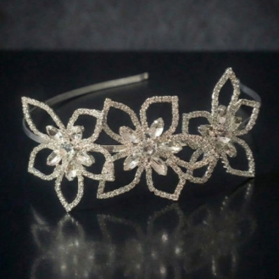 Silver floral tiara with precisely cut clear crystals arranged in a blooming flower pattern.