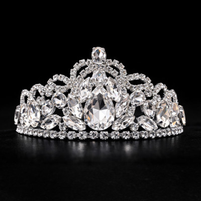 Silver tiara with a veil-like pattern of sparkling clear crystals and intricate handcrafted metalwork.