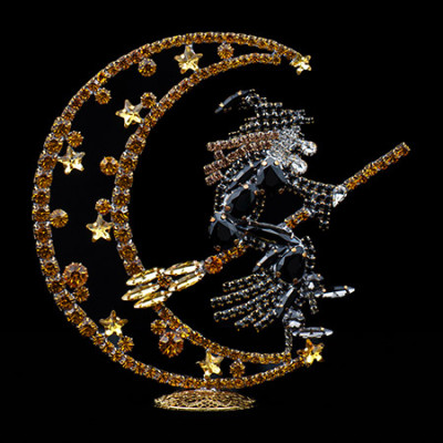 Rhinestone witch flying on a broomstick, sitting on a crescent moon.