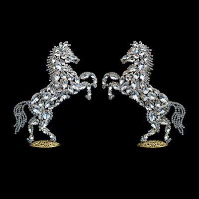 Decorative set of two rearing horse figurines made from clear rhinestones.