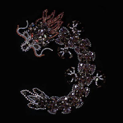 Handmade rhinestone brooch with a purple Chinese dragon.