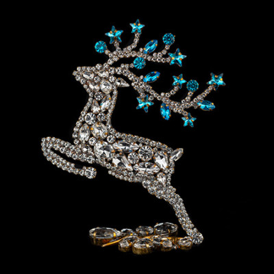 Rhinestone reindeer figurine with yellow rhinestones - facing left.