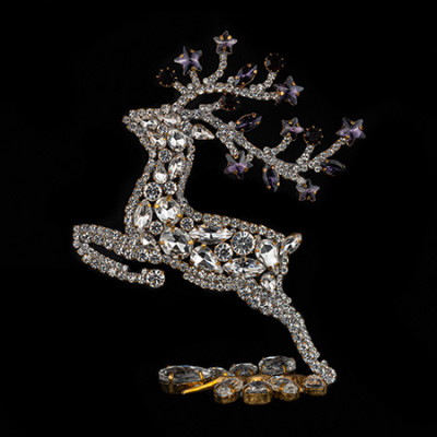 Decorative reindeer figurine with clear rhinestones - facing left