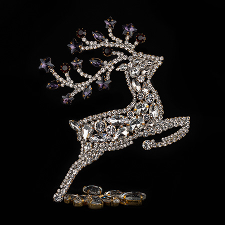 Decorative reindeer figurine with clear rhinestones - facing right.