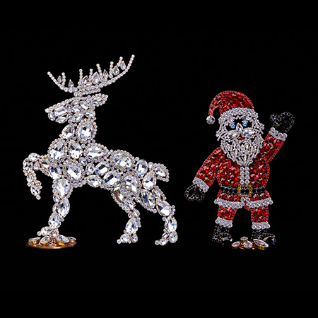 Handcrafted Christmas decoration of Santa Claus and valiant reindeer.